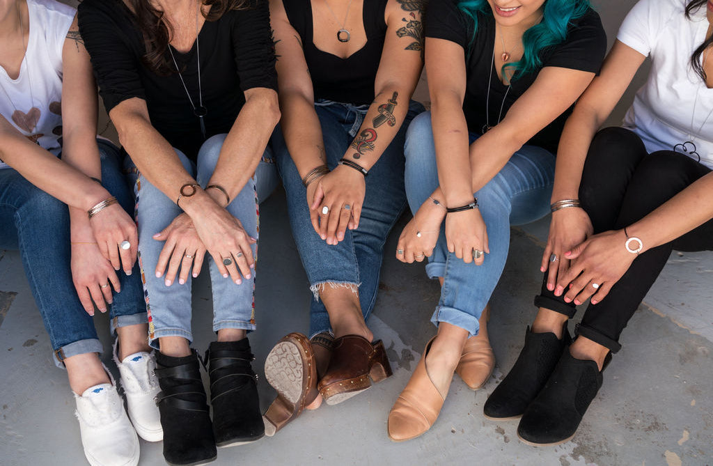 group of women sitting together wearing jewelry