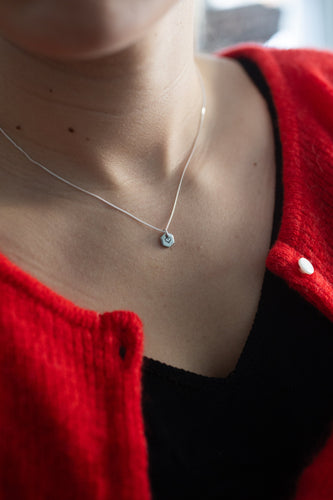 Known Heart close up silver necklace red sweater