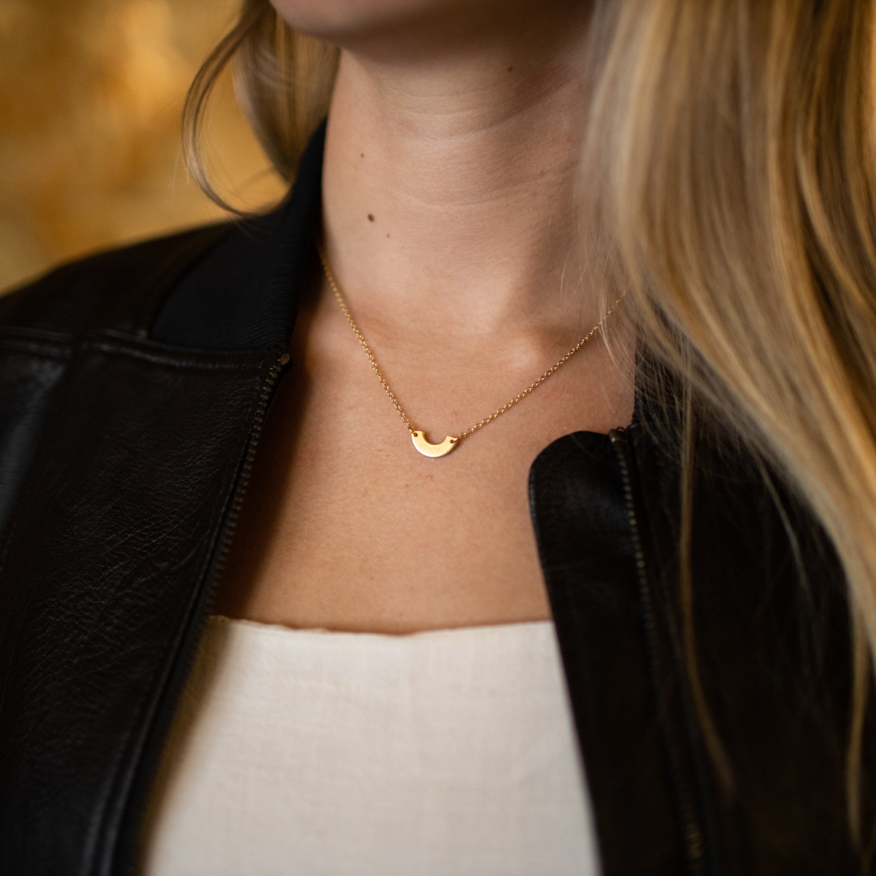 Gold-plated necklace with brass washer made by abuse survivors