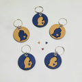 A collection of circular and rectangular leather keychains in various colors attached to metal rings.