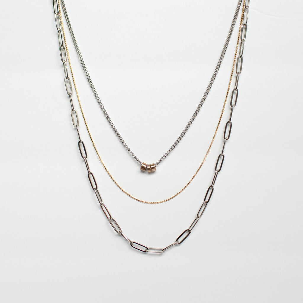three strand necklace stainless steel brass copper against white background