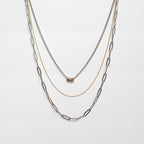 three strand necklace stainless steel brass copper against white background